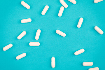 A bunch of pills on a blue background. The concept of healthcare
