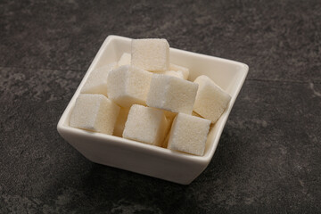 Refined white sugar cubs in the bowl