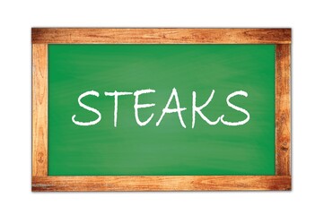 Obraz premium STEAKS text written on green school board.