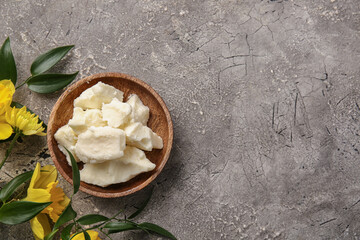 Plate with shea butter on grunge background
