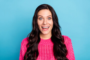 Portrait of attractive amazed cheerful wavy-haired girl laughing having fun isolated over bright blue color background