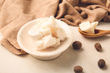 Plate with shea butter on light background
