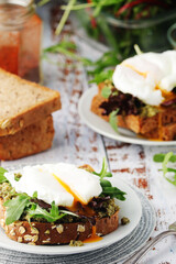 Homemade sandwiches with pesto, green salad and poached eggs	