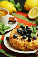 Belgian waffles with blueberry and a cup of tea with lemon