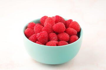A bowl with ripe bright raspberries