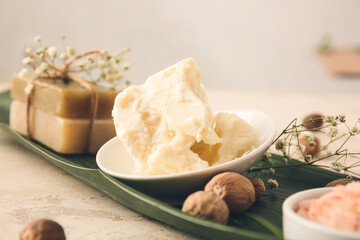 Plate with shea butter on table