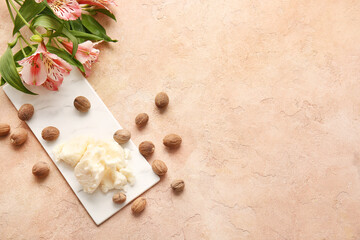 Shea butter with nuts on color background