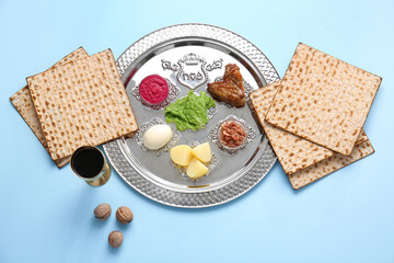 Passover Seder plate with traditional food on color background