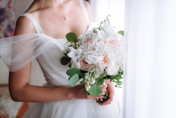 bride holding a bouquet of flowers in a rustic style, wedding bouquet. Soft focus