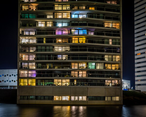 Groningen, Holland - 2021-01-20: View of a front of a apartment building. With many colors in each window.