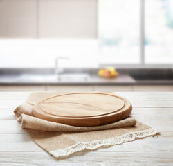 Napkin and board for pizza on wooden desk. Kitchen background.