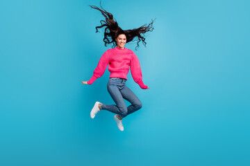 Obraz premium Full size photo of jumping person hair flying have good mood toothy smile isolated on blue color background