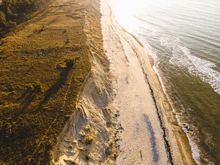 Jurkalne steep shore at autumn sunset with small waves in the sea, Latvia, Jurkalne. 2020 autumn