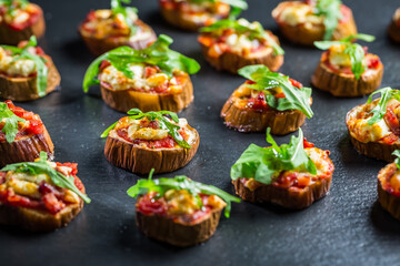 Mini eggplant appetizers with tomato, cheese and salad