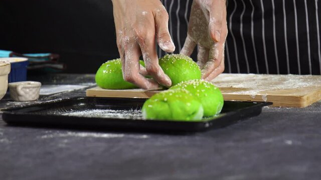 Dough making, Homemade bread making, man pick fresh raw dough to rectangle tray, Professional baker man cooking buns in kitchen