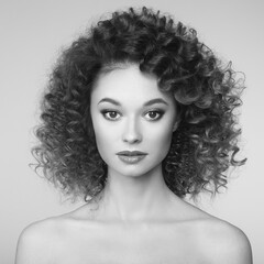 Fototapeta premium Beautiful woman face. Perfect makeup. Beauty fashion. Cosmetic. Eyeshadow. Elegant afro curly hairstyle. Black and white photo.