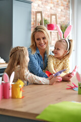 Happy mom and two little daughters in Easter time