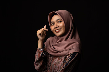 Fashion portrait of young beautiful asian muslim woman with wearing hijab isolated on black background.