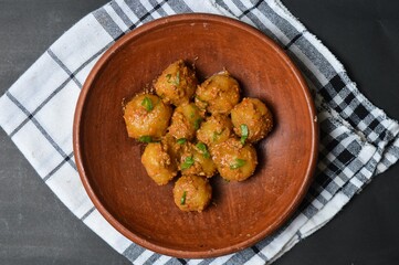 Cilok is balls prepared with a base of tapioca flour. Whether boiled or fried, cilok balls are typically accompanied by a sweet peanut sauce or spicy sauces based on ketchup and kecap manis. 