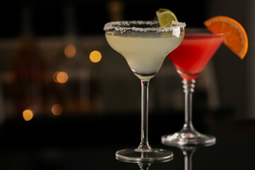 Different delicious cocktails on counter in bar