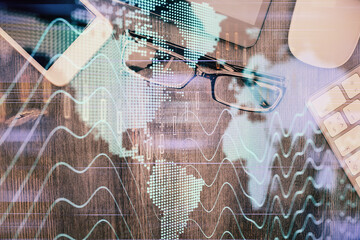 Multi exposure of forex graph hologram over desktop with phone. Top view. Mobile trade platform concept.