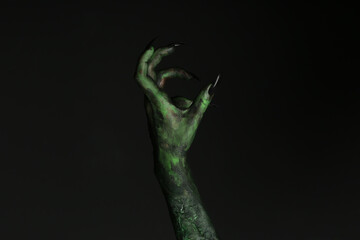 Obraz premium Scary monster on black background, closeup of hand. Halloween character