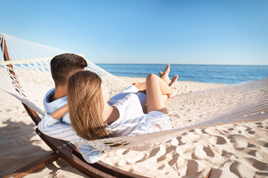 Couple Relaxing In Hammock On Beach. Summer Vacation