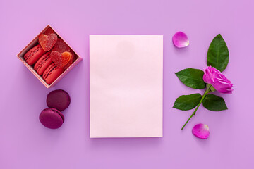 Valentine's day concept. Pink box with marmalade and gift macaroons and a beautiful rose on a pink background