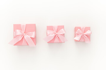 Valentines day composition: three pink gift boxes with ribbon