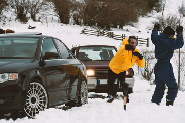 Two friends fighting with snowballs in the snow