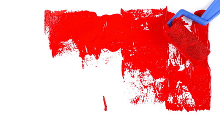 Paint roller soaked in red paint, smeared color isolated on white background, top view