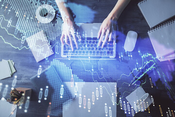 Multi exposure of woman hands working on computer and forex chart hologram drawing. Top View. Financial analysis concept.