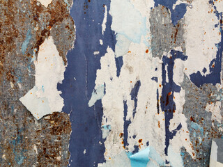 Old torn, ruined and crumpled street poster. Urban background