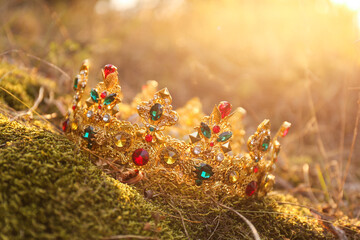 Beautiful golden crown on grass outdoors. Fantasy item © New Africa