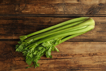 Fresh ripe green celery on wooden table, top view