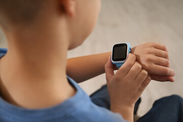 Boy with stylish smart watch, closeup view