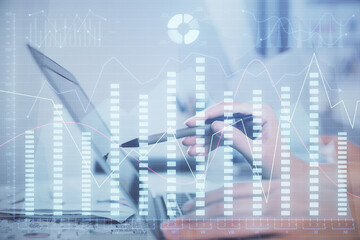 Obraz premium Multi exposure of woman hands typing on computer and financial graph hologram drawing. Stock market analysis concept.