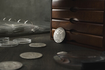 Numismatics. Old collectible coins made of silver on a wooden table.