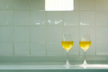 Two glasses of white wine on cement table. Alcohol drink for celebration New year, Valentines, Christmas.