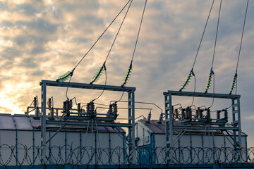 Electrical substation with wires at dawn.