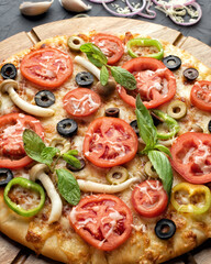 Pizza with tomato,olives and mushroom. Italian cuisine. Ingredients for making pizza on a black background. Top view.Concept for advertising restaurants or pizzerias.