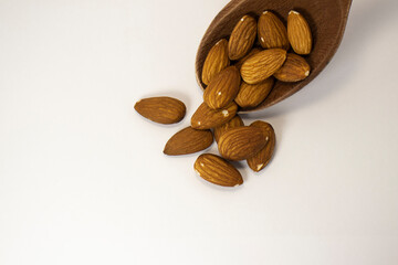 nuts in spoon on white isolated background with copy space