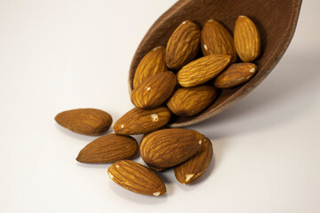 nuts in spoon on white isolated background with copy space