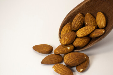 nuts in spoon on white isolated background with copy space