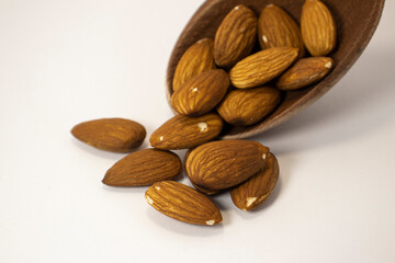 nuts in spoon on white isolated background with copy space