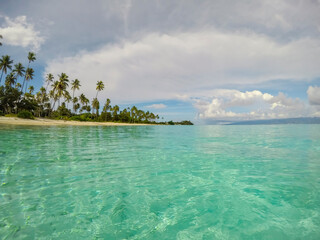 Beautiful tropical paradise beach with turquoise water and palms in Moorea Island, French Polynesia.Holidays travel and summer vacation concept background.