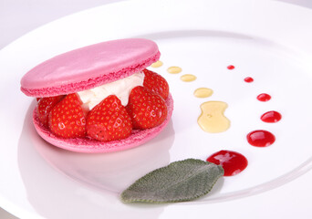 Macaron-like dessert with cheese cream and strawberries on white background. Close-up.