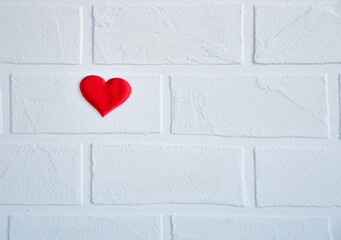 red heart on a white brick wall