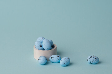 quail blue easter eggs on blue background. Minimal comcept with copy space. spring holidays decor