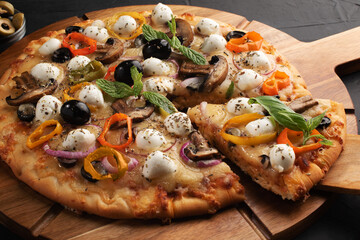 Pizza with mozzarella ,olives and mushroom. Italian cuisine. Ingredients for making pizza on a black background.Top view.Concept for advertising restaurants or pizzerias.